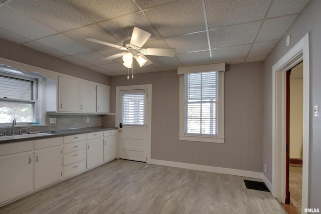 kitchen with light hardwood / wood-style floors, sink, white cabinetry, a paneled ceiling, and ceiling fan