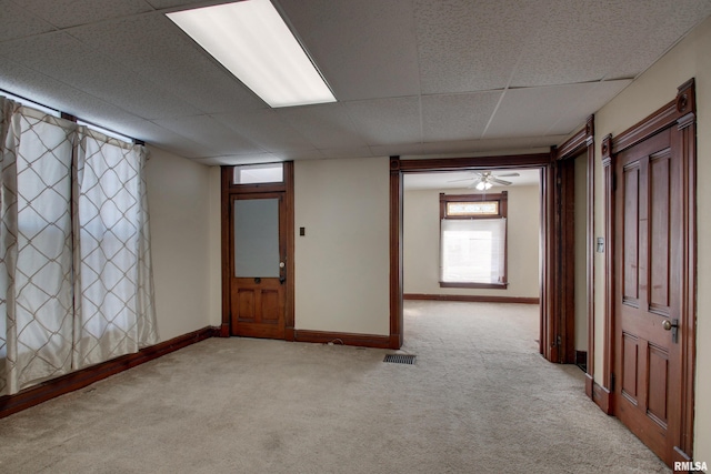 carpeted empty room featuring a paneled ceiling and ceiling fan