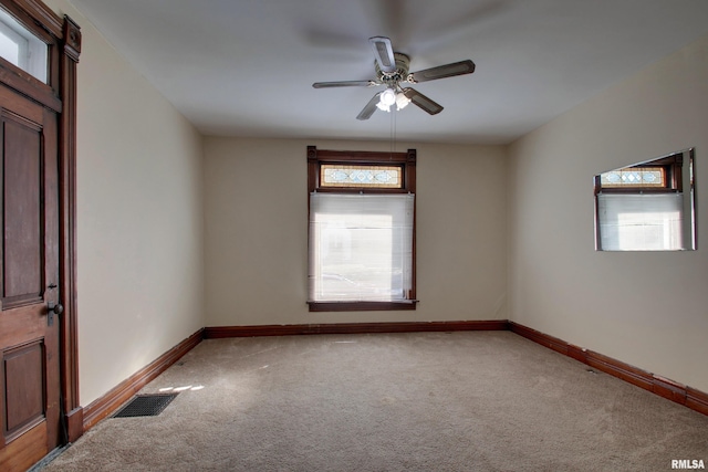 carpeted empty room featuring ceiling fan