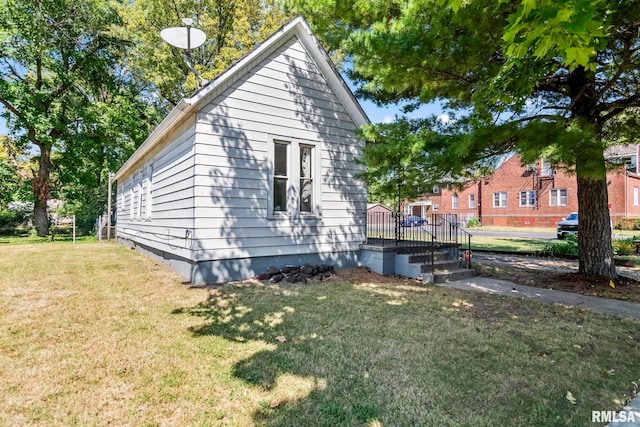 view of side of property with a yard