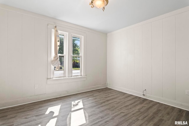 unfurnished room with dark hardwood / wood-style floors