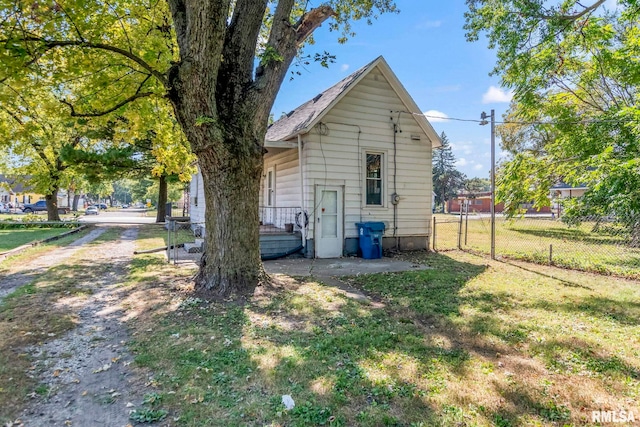 view of side of home with a lawn