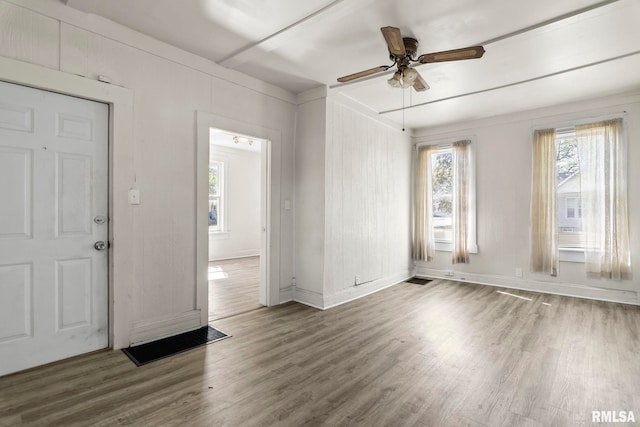 empty room with ceiling fan and hardwood / wood-style flooring