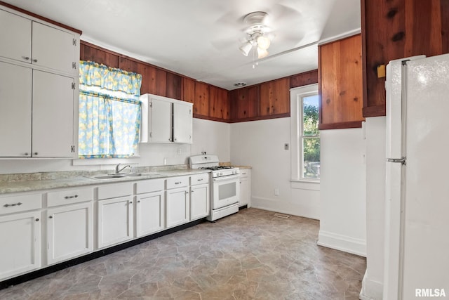 kitchen featuring white cabinets, white appliances, ceiling fan, and sink