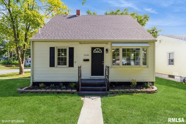 bungalow-style home featuring a front yard