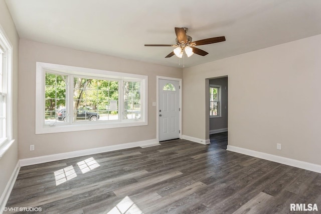 unfurnished room with dark hardwood / wood-style flooring, ceiling fan, and a healthy amount of sunlight