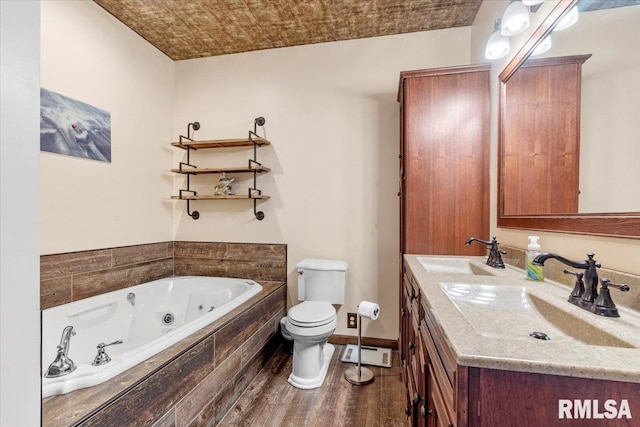 bathroom with wood-type flooring, a relaxing tiled tub, vanity, and toilet