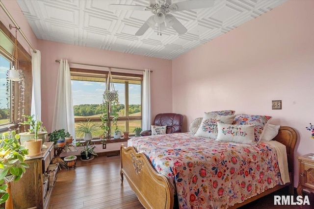 bedroom featuring ceiling fan and dark wood-type flooring