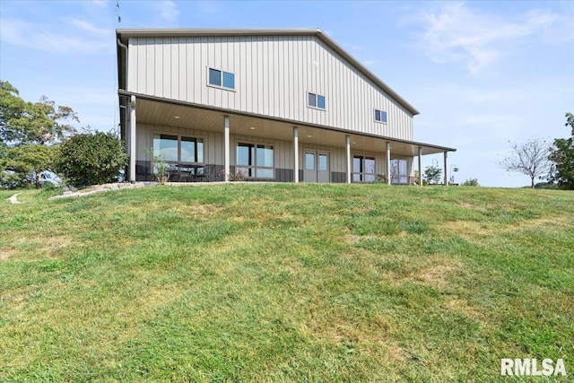 rear view of property with a yard