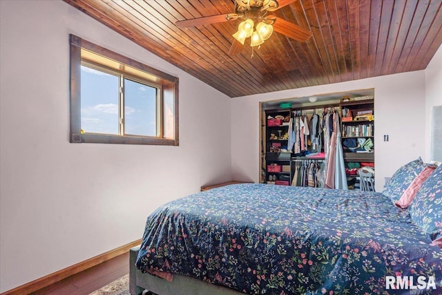 bedroom featuring ceiling fan, wood ceiling, a closet, and wood-type flooring