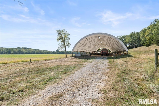 view of outbuilding with a carport and a rural view