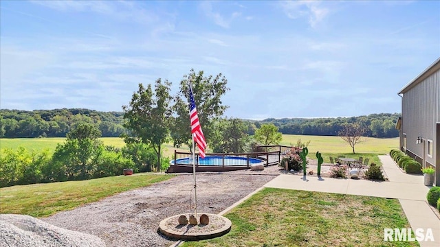 view of yard with a patio and an outdoor fire pit