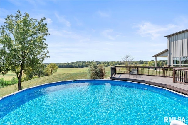 view of pool with a deck and a lawn