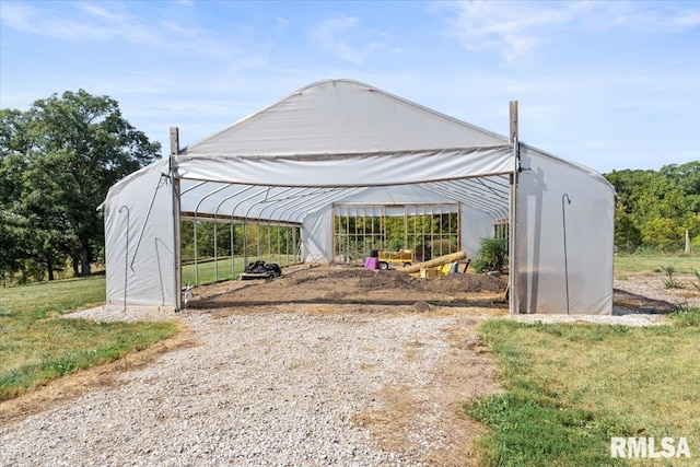 view of gate with a lawn