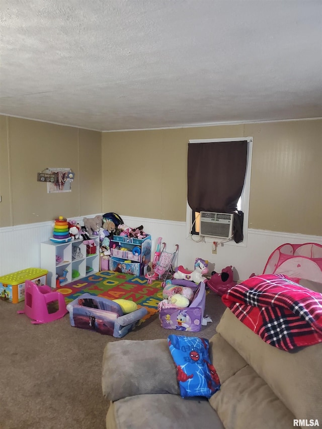 interior space featuring a textured ceiling, cooling unit, and carpet floors