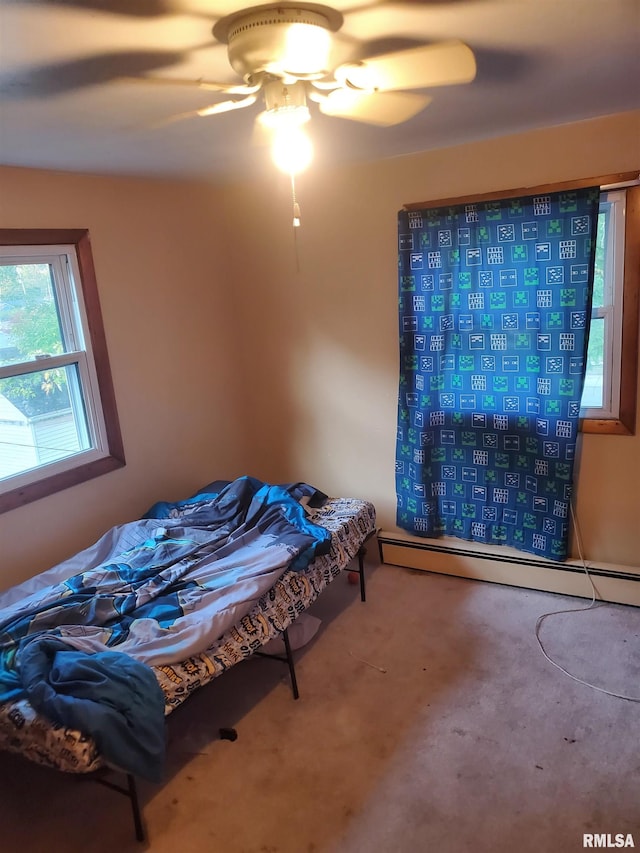 bedroom with ceiling fan, a baseboard radiator, and carpet flooring