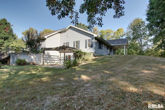 view of home's exterior with a lawn and a pergola