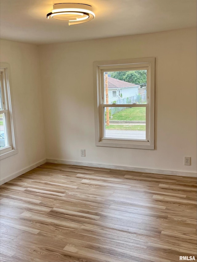 spare room with light hardwood / wood-style flooring