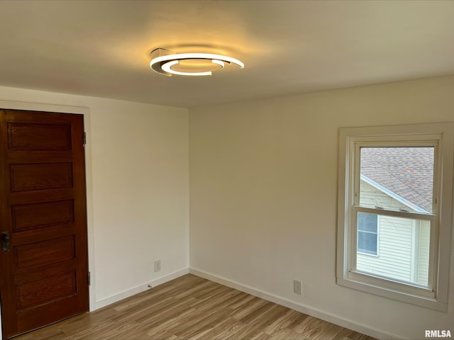 empty room with light hardwood / wood-style flooring