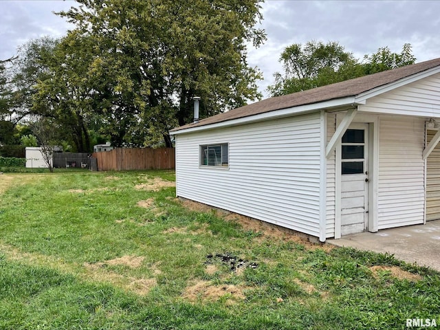 view of outbuilding featuring fence