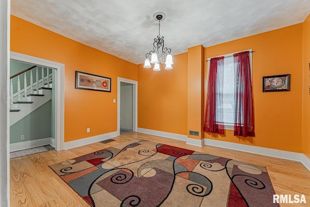 entrance foyer featuring hardwood / wood-style floors and a notable chandelier