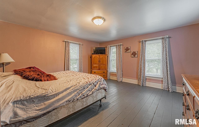 bedroom with dark wood-type flooring