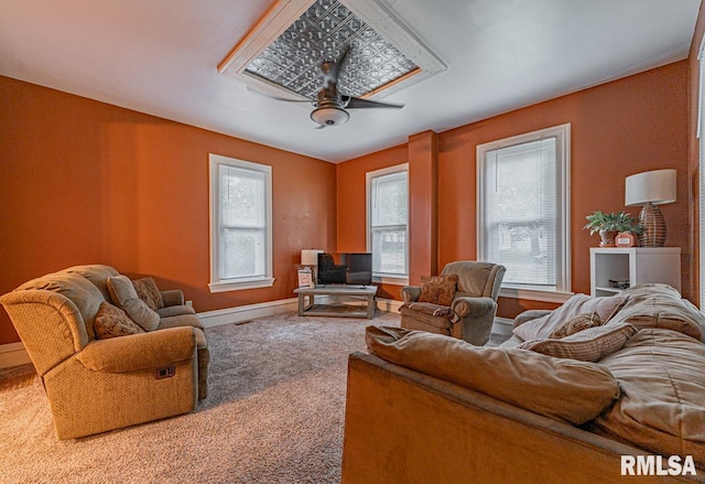 living room featuring carpet and ceiling fan