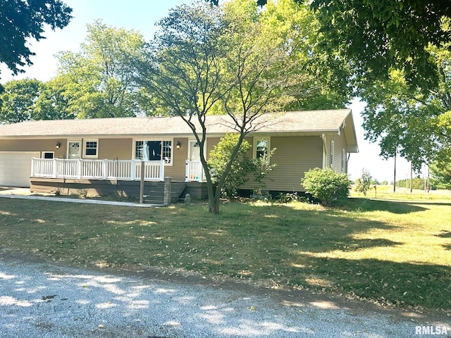 view of front of house featuring a wooden deck, a front lawn, and a garage