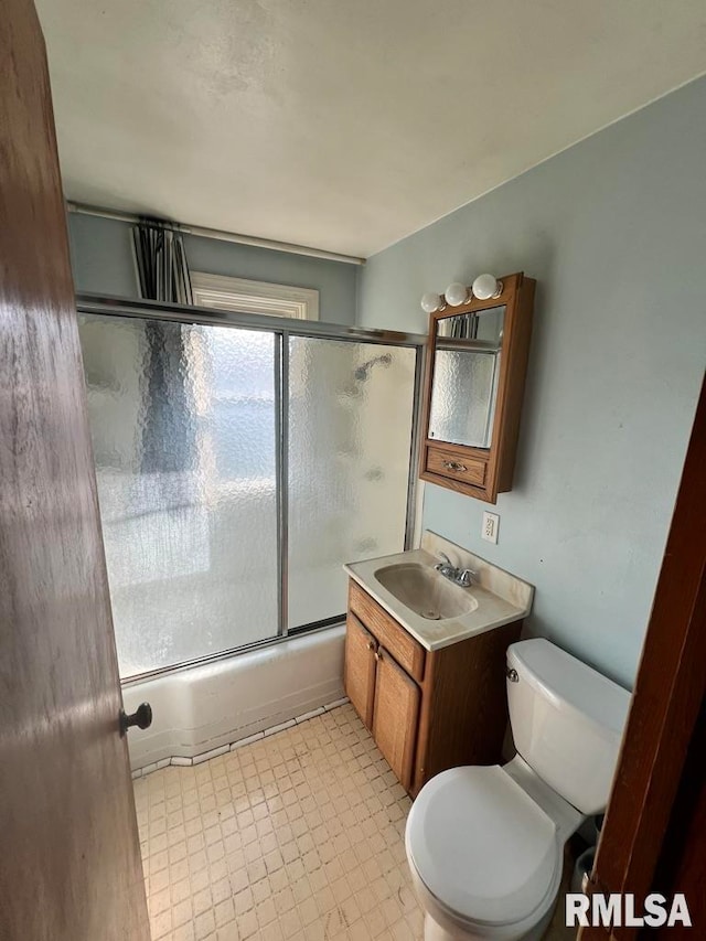 full bathroom with vanity, toilet, and bath / shower combo with glass door