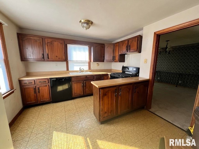 kitchen featuring black appliances, kitchen peninsula, and sink