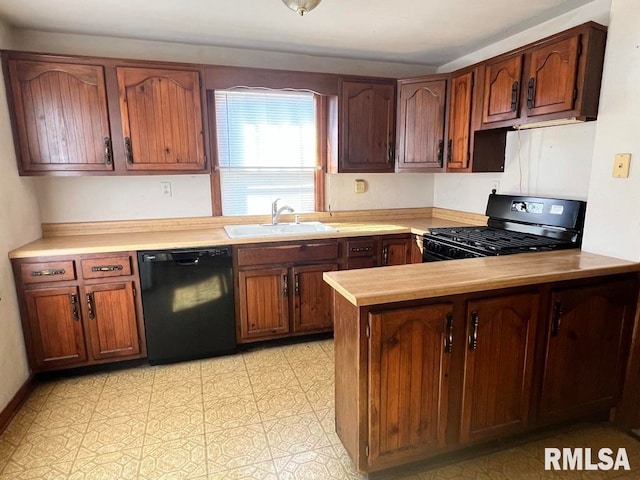 kitchen featuring black appliances, kitchen peninsula, and sink