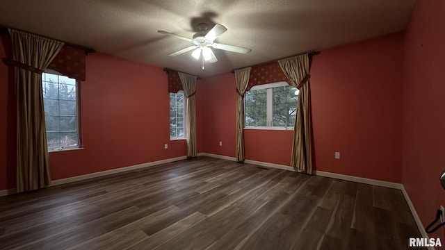 spare room featuring a textured ceiling, dark hardwood / wood-style flooring, and ceiling fan