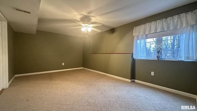 spare room featuring ceiling fan and carpet