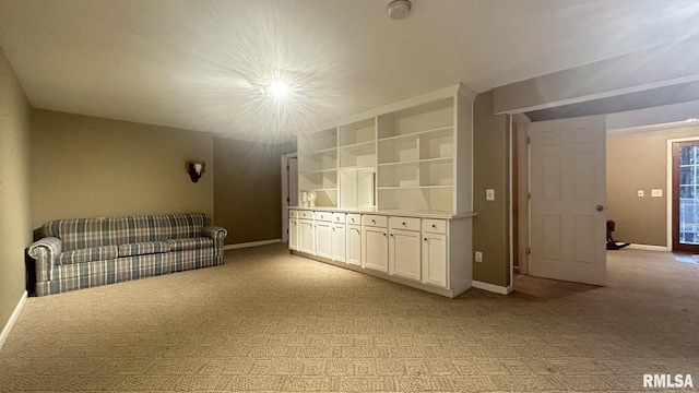 unfurnished living room featuring light colored carpet