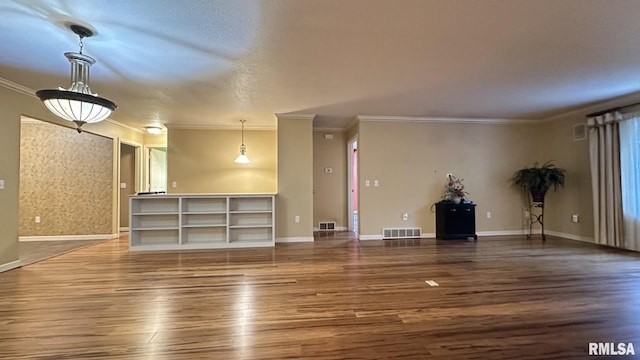 unfurnished living room featuring hardwood / wood-style flooring and ornamental molding