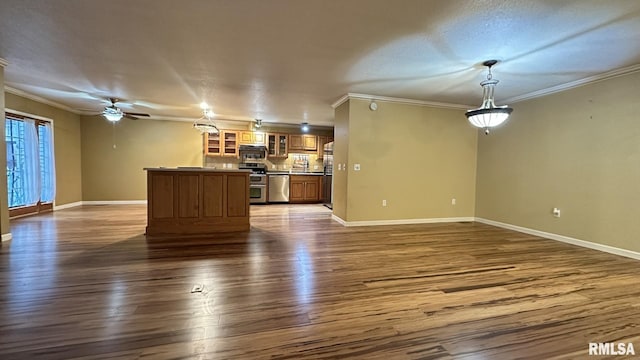 unfurnished living room featuring dark hardwood / wood-style flooring, ceiling fan, and ornamental molding