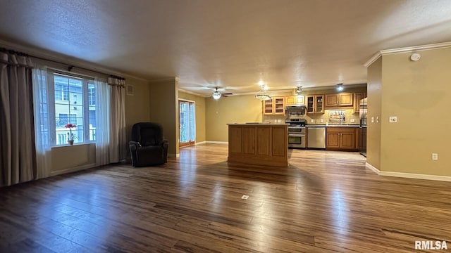 unfurnished living room featuring hardwood / wood-style flooring, ceiling fan, and crown molding