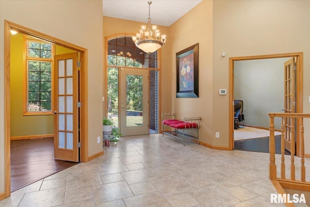 entrance foyer featuring an inviting chandelier, light wood-type flooring, and a healthy amount of sunlight