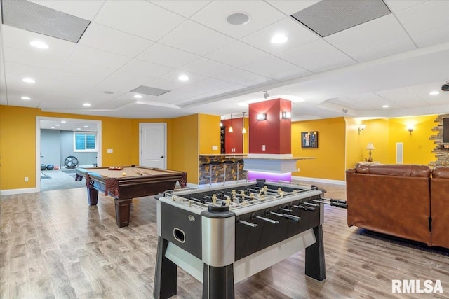 recreation room featuring pool table, a paneled ceiling, light hardwood / wood-style floors, and bar area