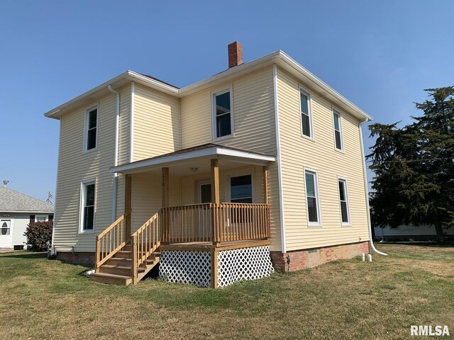 back of house with a porch and a yard