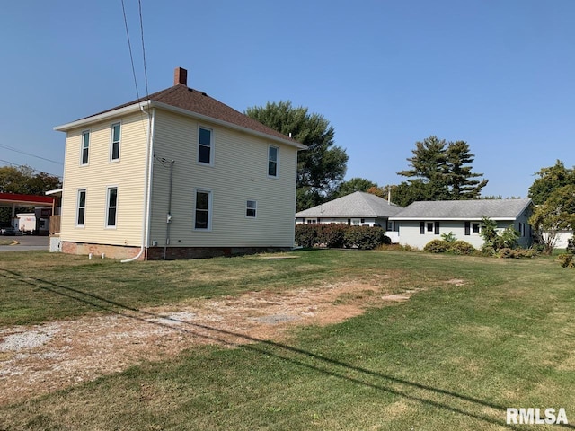 rear view of property featuring a yard