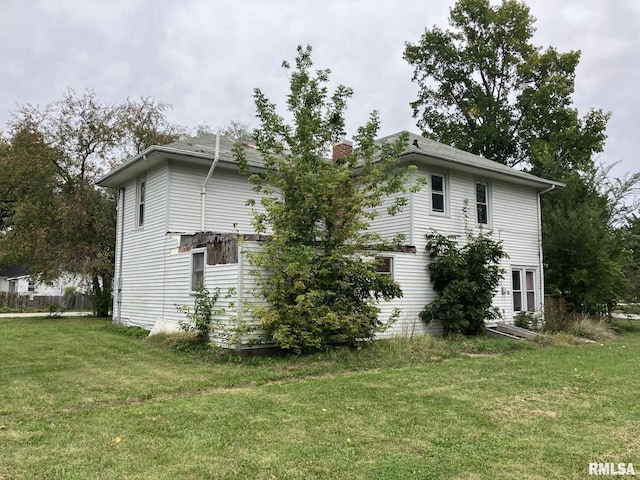 view of property exterior with a yard