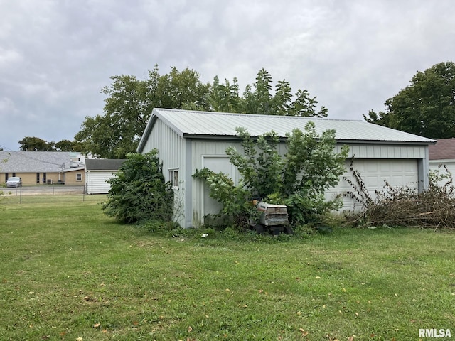 exterior space featuring a garage and a yard