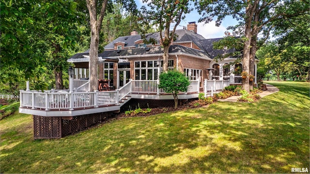 back of house with a deck and a yard