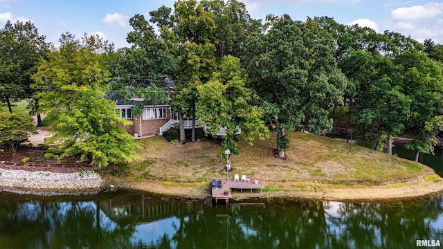 back of house featuring a water view and a yard