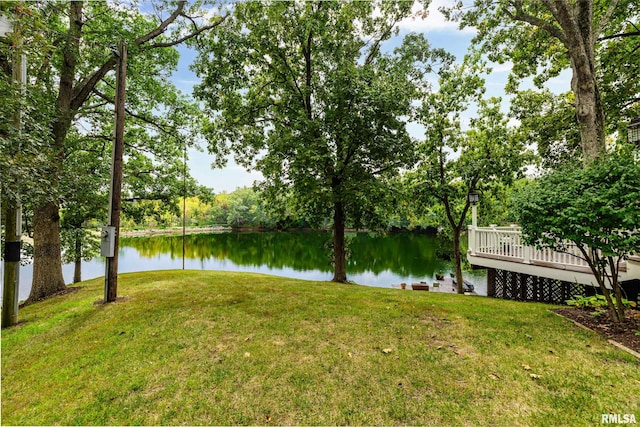 view of yard with a deck with water view