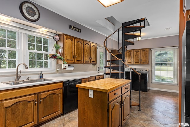 kitchen with black dishwasher, sink, a kitchen island, ornamental molding, and butcher block countertops