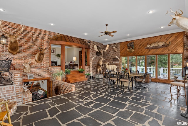 living room with brick wall and wooden walls