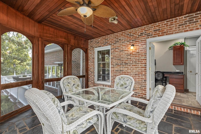 sunroom with wooden ceiling, a healthy amount of sunlight, and ceiling fan