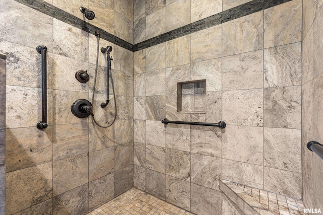 bathroom with a tile shower